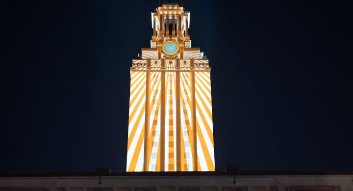 Rays of light are projected on the UT Tower after dark as part of an Arts and Entertainment Technologies event.