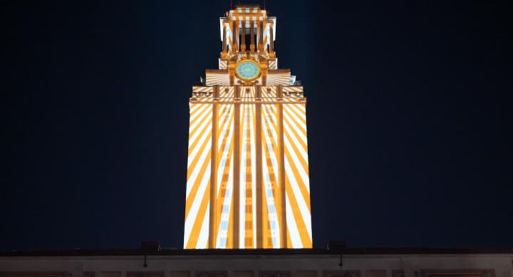 Rays of light are projected on the UT Tower after dark as part of an Arts and Entertainment Technologies event.